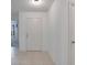 Simple entryway with white door and light tile floor at 2711 Angel Mist Ct, Mascotte, FL 34753