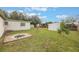 Large backyard with fire pit, storage sheds, and grassy area at 2914 Sprague Dr, Orlando, FL 32826