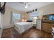 Cozy bedroom with a double bed, dresser, and wood floors at 2914 Sprague Dr, Orlando, FL 32826