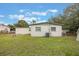 Rear view of the house showing AC unit and large yard at 2914 Sprague Dr, Orlando, FL 32826