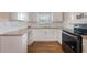 U-shaped kitchen with granite countertops and white cabinets at 2914 Sprague Dr, Orlando, FL 32826