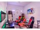 Fun game room with gaming chairs, arcade game, and big screen TV at 2957 Beach Palm Ave, Kissimmee, FL 34747