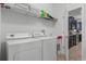 Laundry room with washer, dryer, and shelving at 2957 Beach Palm Ave, Kissimmee, FL 34747