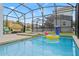 Screened patio with pool and inflatable at 2957 Beach Palm Ave, Kissimmee, FL 34747