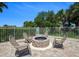 Stone fire pit with four surrounding chairs at 3 Riverwalk Dr # 405, New Smyrna Beach, FL 32169