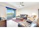 Living room with leather sofas, coffee table, and sliding door to balcony at 3 Riverwalk Dr # 405, New Smyrna Beach, FL 32169