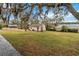 Large backyard with grassy area and mature trees at 30845 Westward Ho Ave, Sorrento, FL 32776