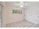 Simple bedroom with window and ceiling fan at 30845 Westward Ho Ave, Sorrento, FL 32776