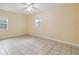 Spacious bedroom with tile floors and large windows at 30845 Westward Ho Ave, Sorrento, FL 32776