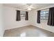 Bedroom with ceiling fan and large windows at 30845 Westward Ho Ave, Sorrento, FL 32776