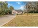 Detached garage with paved driveway and green space at 30845 Westward Ho Ave, Sorrento, FL 32776