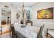 Bright dining room with a chandelier and view into kitchen at 3566 Tropical Seas Loop, Tavares, FL 32778