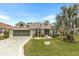 Attractive single-story house with a two-car garage and landscaped front yard at 3566 Tropical Seas Loop, Tavares, FL 32778