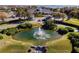 Community fountain with pond and clubhouse view at 3566 Tropical Seas Loop, Tavares, FL 32778