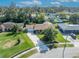 Aerial view of home showcasing well-manicured lawn, mature trees, and a long driveway leading to the garage at 4130 Floralwood Ct, Orlando, FL 32812