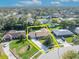 Aerial view of a house with a large yard surrounded by lush greenery and a yellow outline at 4130 Floralwood Ct, Orlando, FL 32812