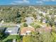 Aerial view featuring the residence and the tranquil neighborhood setting with lush green trees at 4130 Floralwood Ct, Orlando, FL 32812