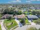 Aerial view of home showcasing well-manicured lawn, mature trees, and a long driveway leading to the garage at 4130 Floralwood Ct, Orlando, FL 32812