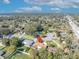 Elevated view of homes in neighborhood with lush trees in a suburban location with city views at 4130 Floralwood Ct, Orlando, FL 32812