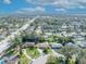 Scenic aerial view capturing a residential neighborhood with lush greenery, houses, and distant water views at 4130 Floralwood Ct, Orlando, FL 32812