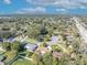 Aerial view featuring the residence and the tranquil neighborhood setting with lush trees at 4130 Floralwood Ct, Orlando, FL 32812