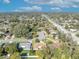 Elevated shot of homes in neighborhood with lush tree coverage in a suburban setting at 4130 Floralwood Ct, Orlando, FL 32812