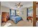 Bedroom featuring wood furniture, bright windows with blue drapes and neutral carpet at 4130 Floralwood Ct, Orlando, FL 32812