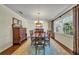 Formal dining room with a large wooden table, patterned rug, and abundant natural light at 4130 Floralwood Ct, Orlando, FL 32812