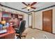 Bright home office featuring ceiling fan, neutral carpet and wallpaper at 4130 Floralwood Ct, Orlando, FL 32812