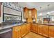 Kitchen with wooden cabinets, granite countertops, black appliances and view to the backyard window at 4130 Floralwood Ct, Orlando, FL 32812