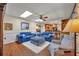 Cozy living room with plush blue sofas, wood floors and view to kitchen area at 4130 Floralwood Ct, Orlando, FL 32812