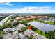 Aerial view of a condo community near a lake, showing the subject property at 5381 Vineland Rd # S, Orlando, FL 32811