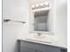 Updated condo bathroom with white vanity and quartz countertop at 5381 Vineland Rd # S, Orlando, FL 32811