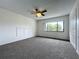 Spacious bedroom with large window and ceiling fan at 5381 Vineland Rd # S, Orlando, FL 32811