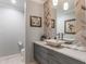 Elegant bathroom with modern vanity and a herringbone patterned wall at 601 Sweetwater Club Blvd, Longwood, FL 32779