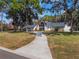 Home exterior showcasing landscaping and a curved driveway at 601 Sweetwater Club Blvd, Longwood, FL 32779