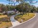 House exterior with a circular driveway and mature trees at 601 Sweetwater Club Blvd, Longwood, FL 32779