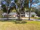 Elegant home nestled among mature trees, showcasing a long driveway at 601 Sweetwater Club Blvd, Longwood, FL 32779