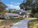 Beautiful home exterior with a curved driveway and lush landscaping at 601 Sweetwater Club Blvd, Longwood, FL 32779