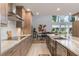 Modern kitchen featuring granite countertops, stainless steel appliances, and a large island at 601 Sweetwater Club Blvd, Longwood, FL 32779