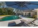 Inviting pool area with lounge chairs, umbrella, and a tranquil fountain at 601 Sweetwater Club Blvd, Longwood, FL 32779