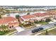 Houses with tile roofs near a lake, aerial view at 6156 Broad Oak Dr, Davenport, FL 33837