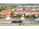 Houses with tile roofs near a lake, aerial view. Two trucks are parked in front of one house at 6156 Broad Oak Dr, Davenport, FL 33837