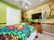 Bedroom with tropical theme, queen-size bed, and custom mural at 6156 Broad Oak Dr, Davenport, FL 33837