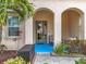 Covered entryway with arched alcoves, blue floor, and seating area at 6156 Broad Oak Dr, Davenport, FL 33837