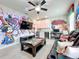 Game room boasts a Disney themed mural and a large screen TV at 6156 Broad Oak Dr, Davenport, FL 33837