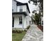 Paved driveway leading to two-story house with gray and white exterior at 62 W Esther W St, Orlando, FL 32806