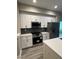 Modern kitchen with white cabinets and stainless steel appliances at 62 W Esther W St, Orlando, FL 32806