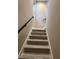 Modern staircase with wood-look treads and black railing at 62 W Esther W St, Orlando, FL 32806