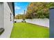 Artificial turf backyard with white fence and a grill at 631 Callahan St, Winter Park, FL 32789